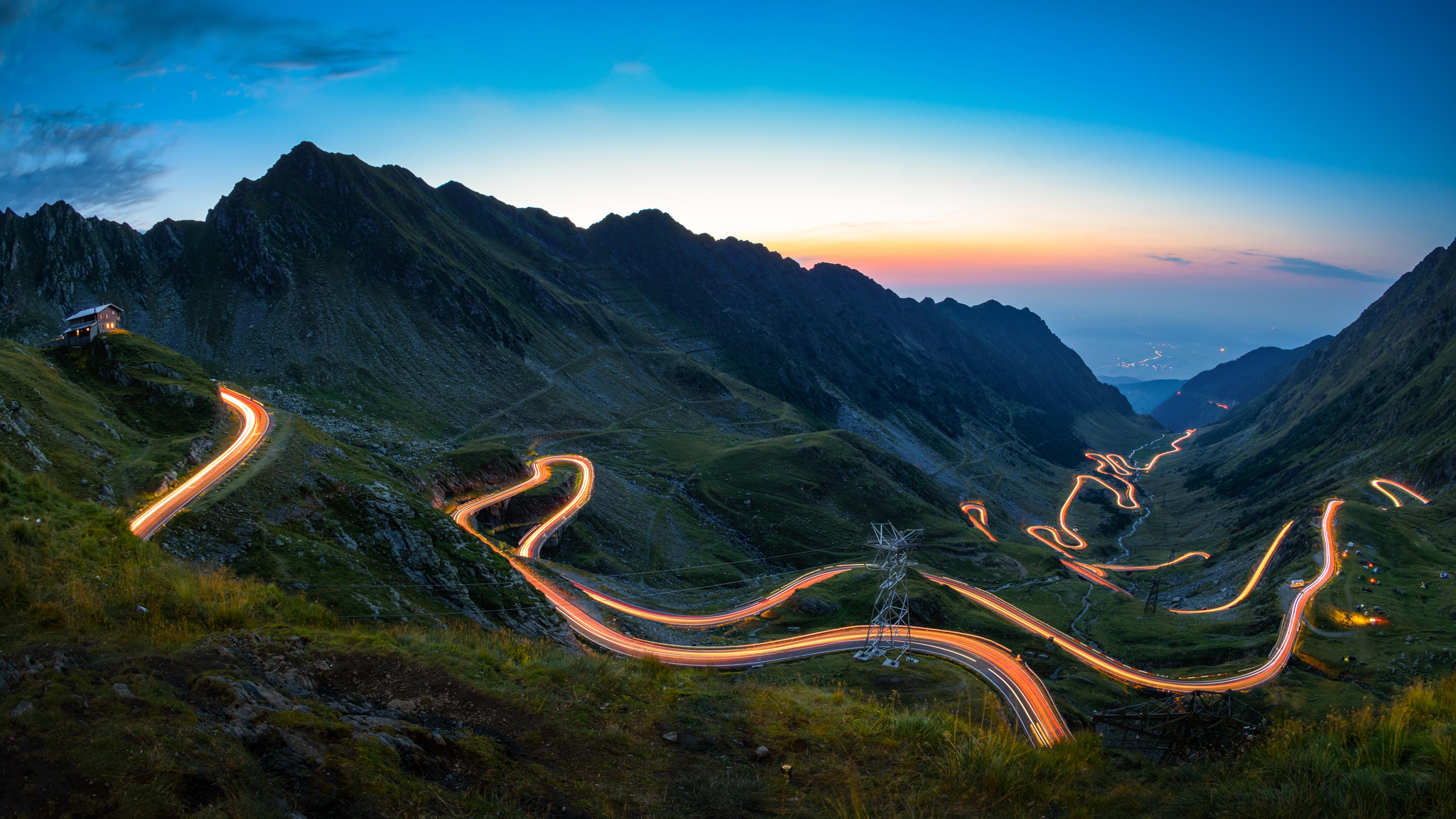 Illuminated road running through a mountain