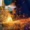Person in a workshop welding with bright orange sparks flying across © Adobe Stock